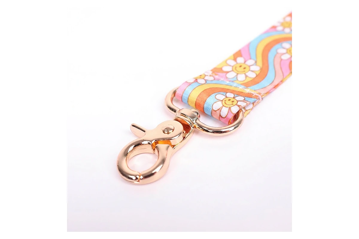 Close view of a stitched floral fabric strap and rose-gold-colored swivel clasp