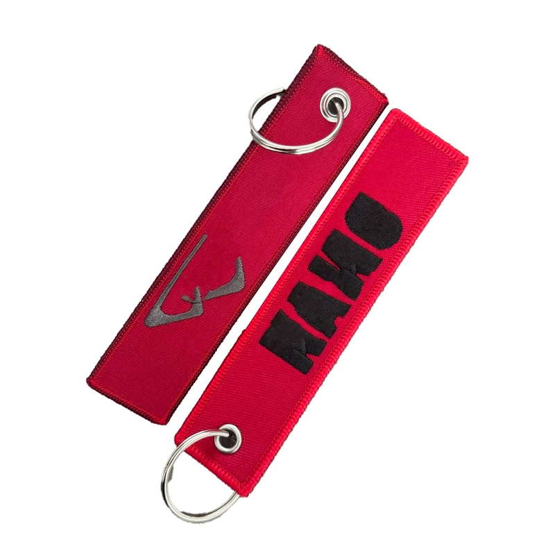 Two red embroidered key tags with metal rings