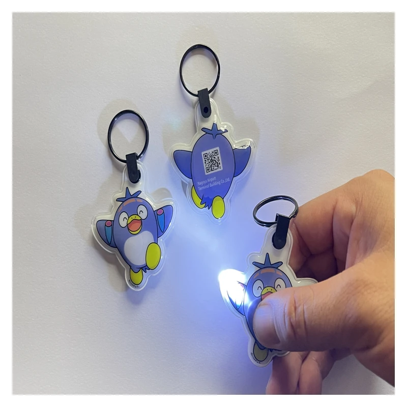 Bird-shaped LED keychain lights with one switched on