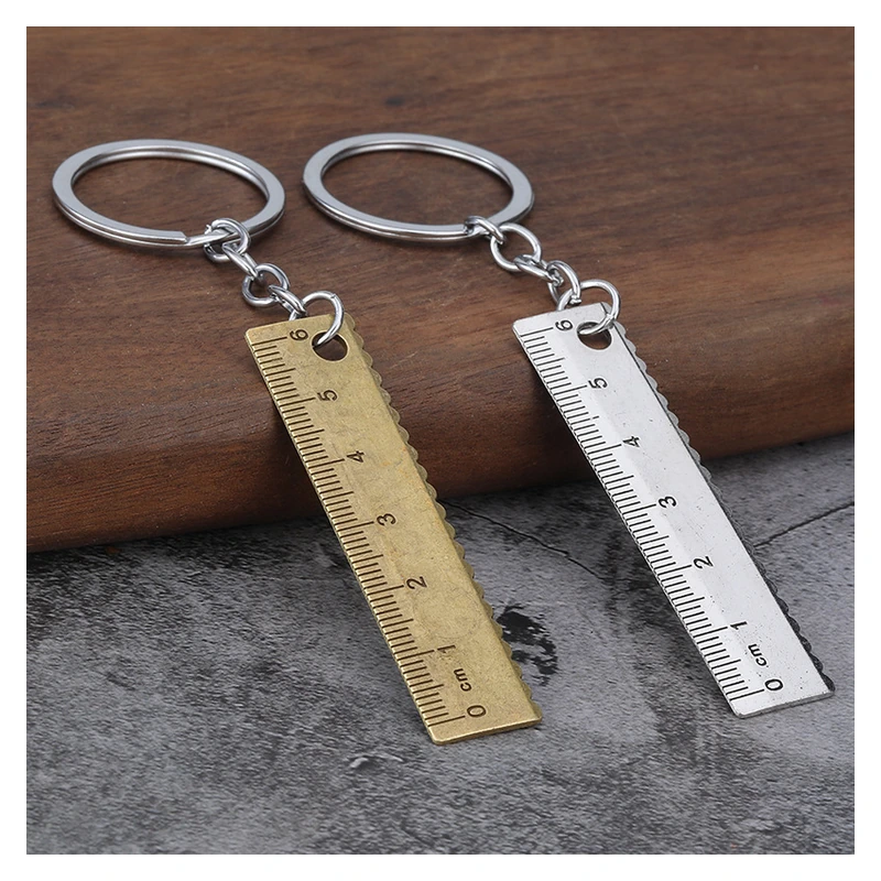Small brass-colored and silver-colored ruler keychains with centimeter markings