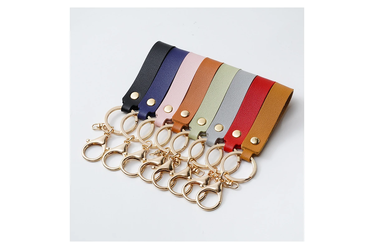 Leather key straps in several colors with gold-tone rings and clips.