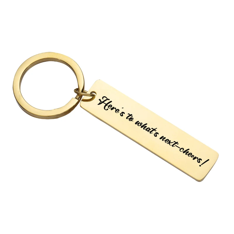 Gold-tone bar keychain with a dark engraved message.