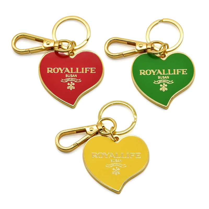 Heart-shaped metal keychains in red, green and yellow with gold-tone lettering.