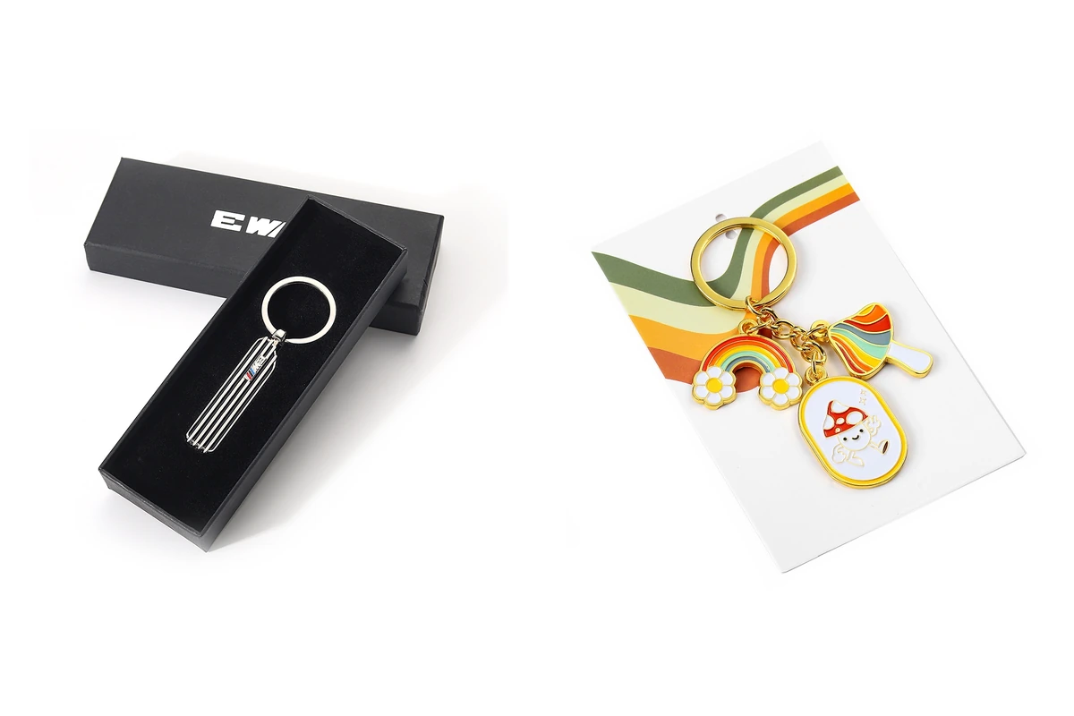 Metal keychain packaging examples with an open black gift box and a printed backing card.
