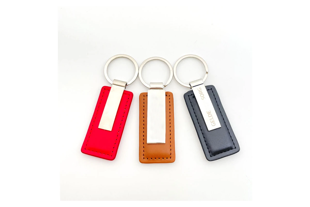 Red, brown and dark leather key tags paired with silver-tone metal plates.