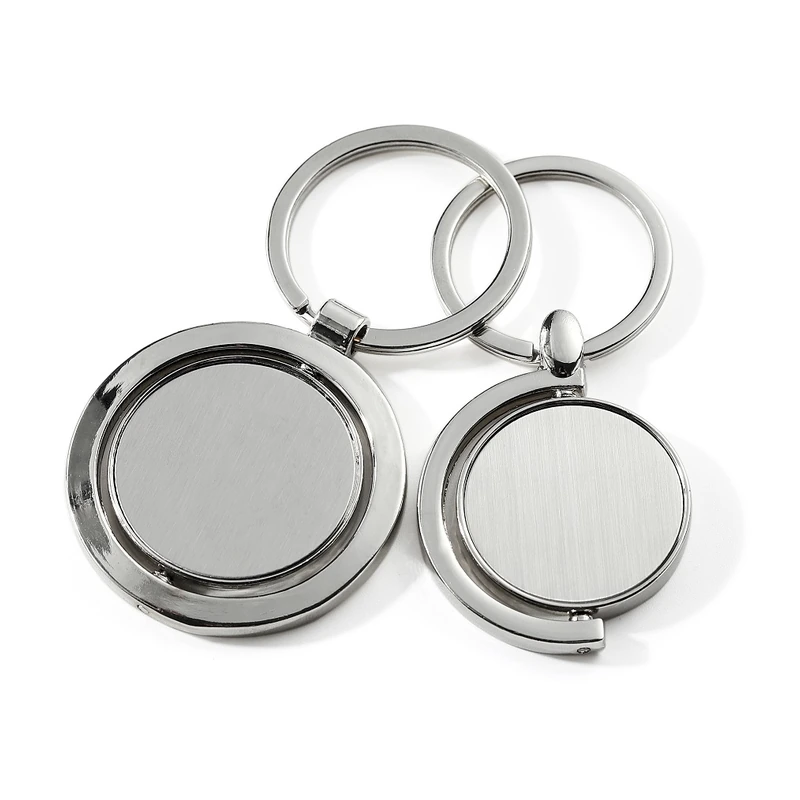 Round silver-tone spinner keychains with brushed rotating center discs.