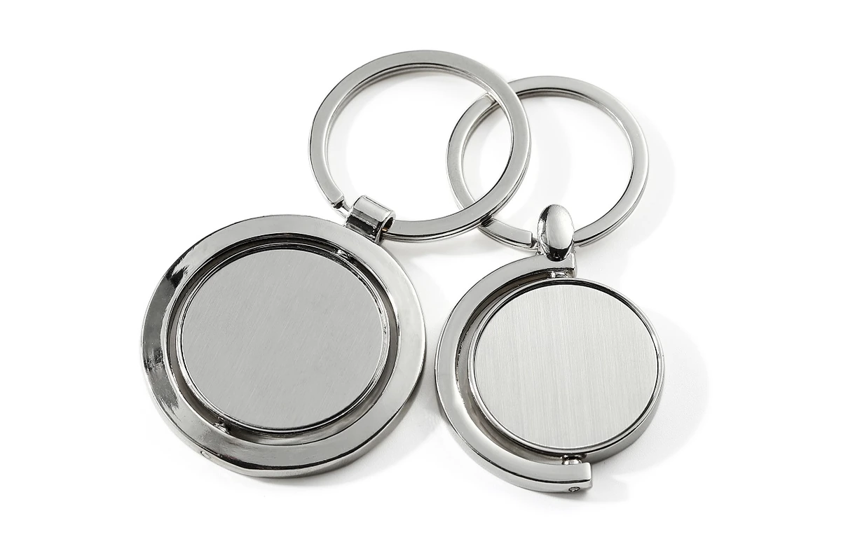 Silver-tone spinner keychains showing their inner discs and pivoting frames.