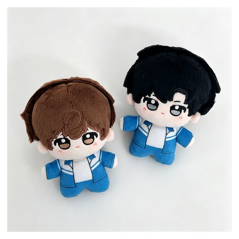Two miniature plush dolls wearing blue outfits