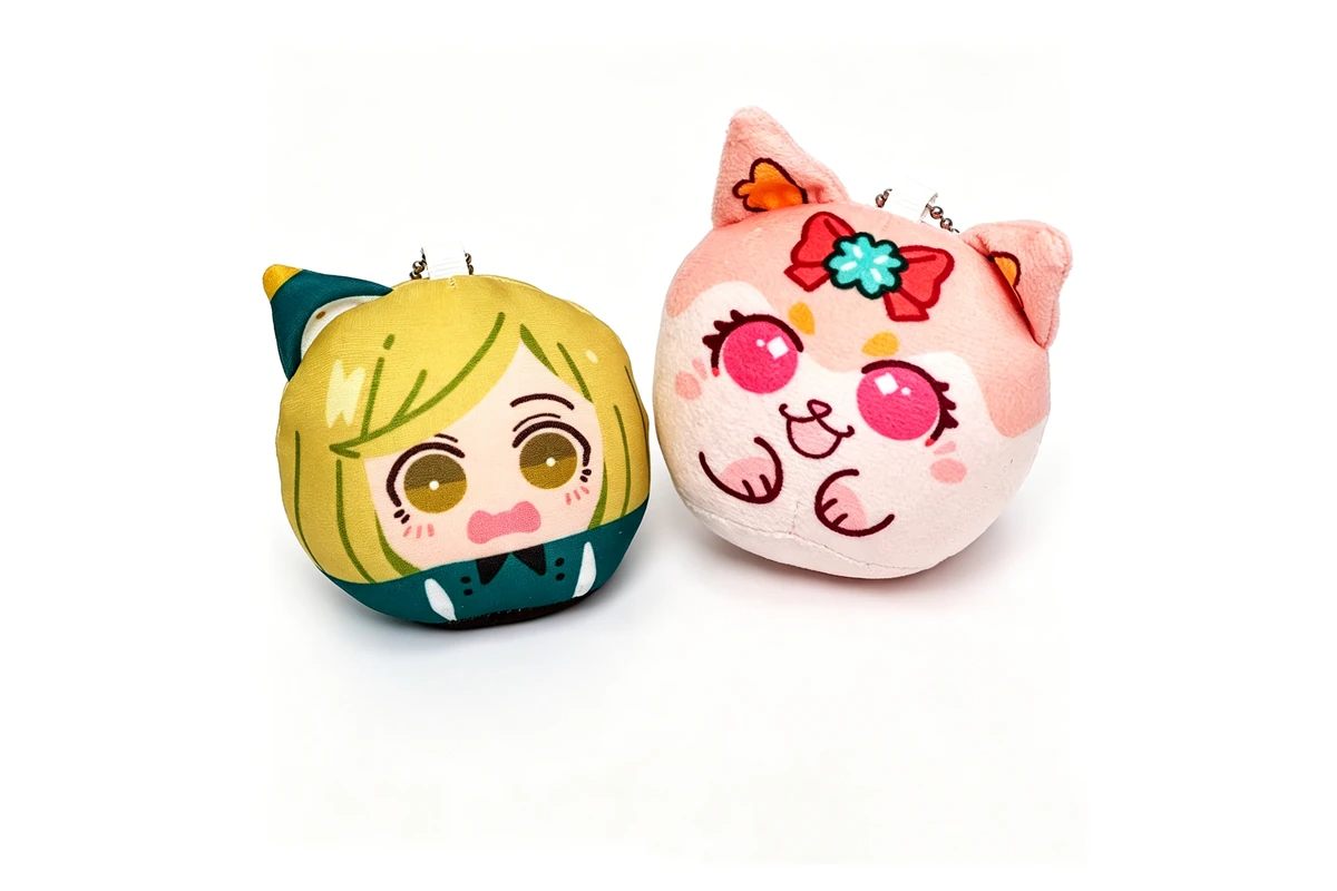 Two printed plush character keychains with shaped soft bodies