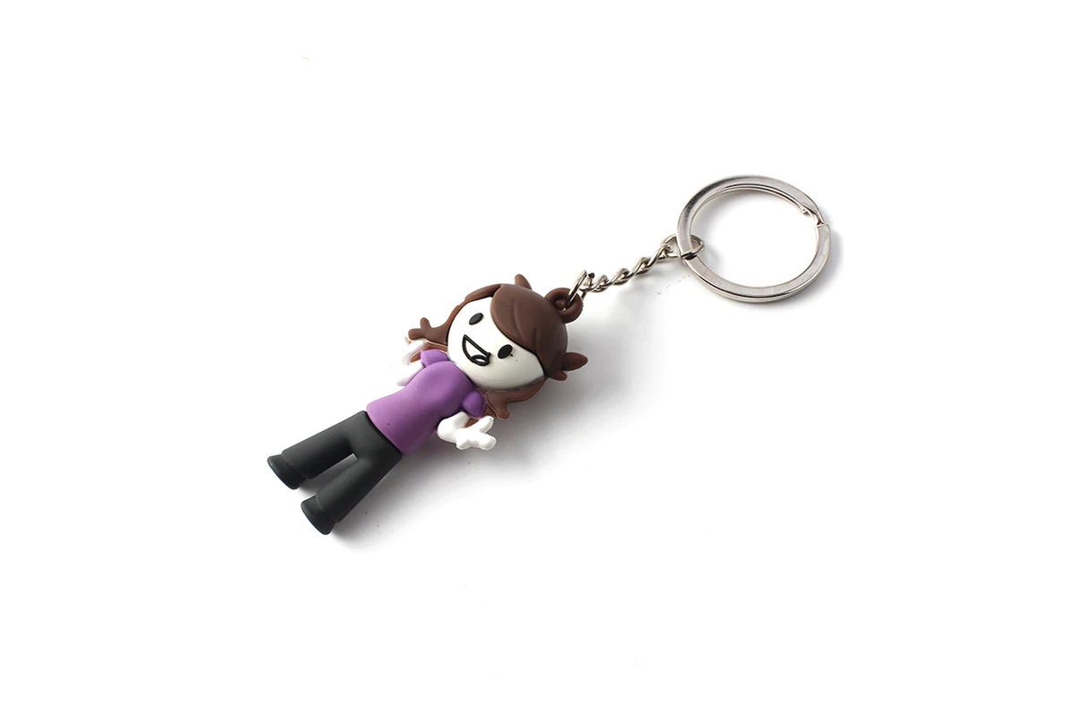 Three-dimensional character keychain with a purple shirt and metal ring.