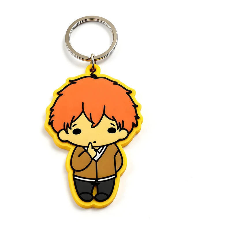 Yellow-edged PVC character keychain with orange hair.