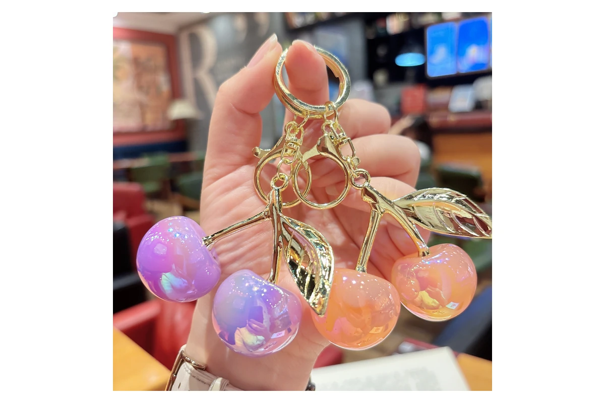 Iridescent cherry-shaped resin charms with gold-colored leaf fittings.
