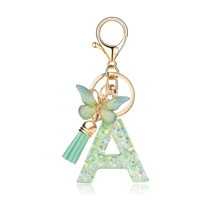 Clear green letter A charm with embedded confetti, a butterfly, and a tassel.