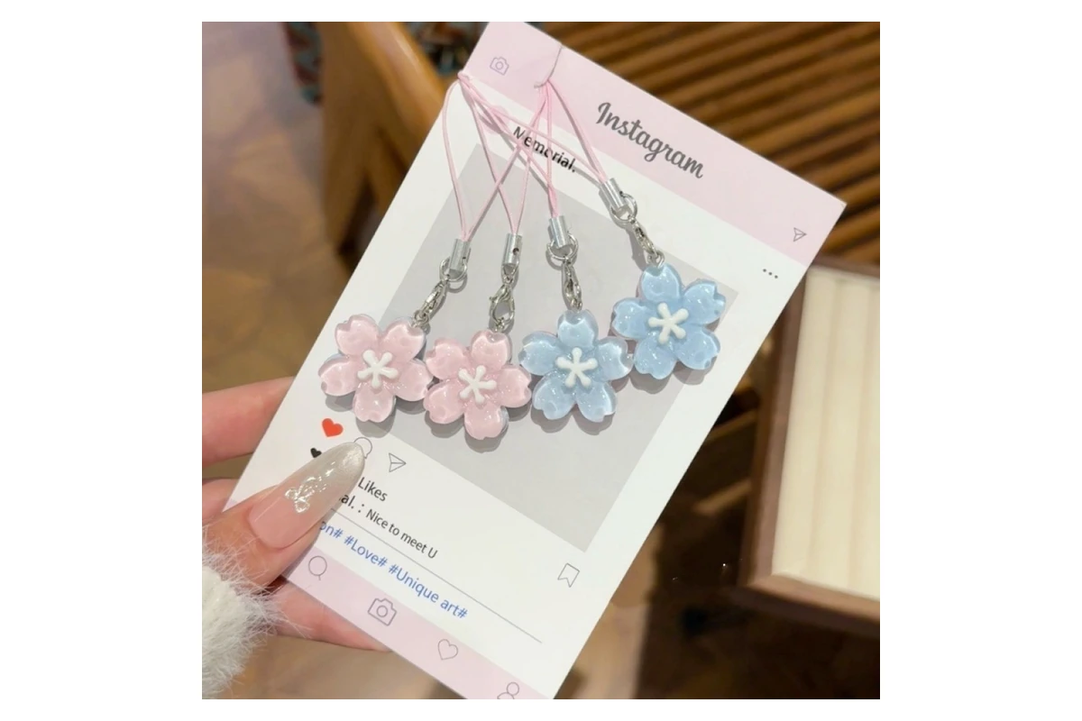 Pastel flower-shaped resin charms displayed across a printed card.