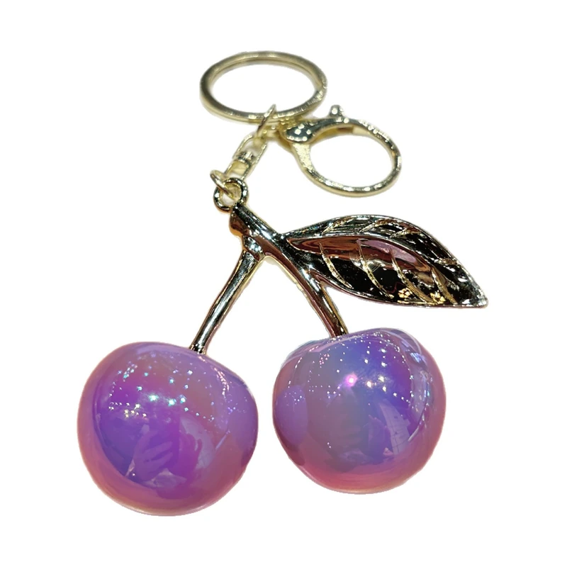 Glossy purple resin cherries with a gold-colored leaf and keyring.