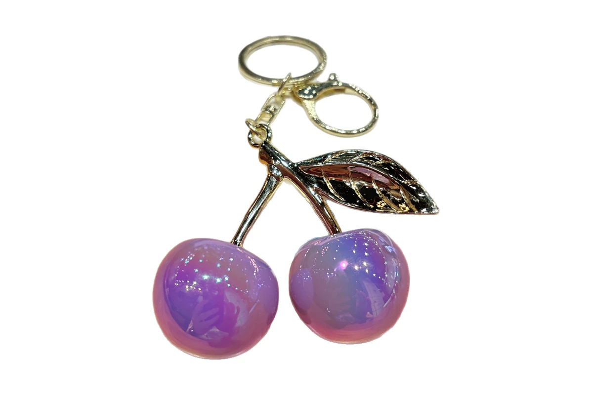 Glossy purple resin cherries with a gold-colored leaf and keyring.