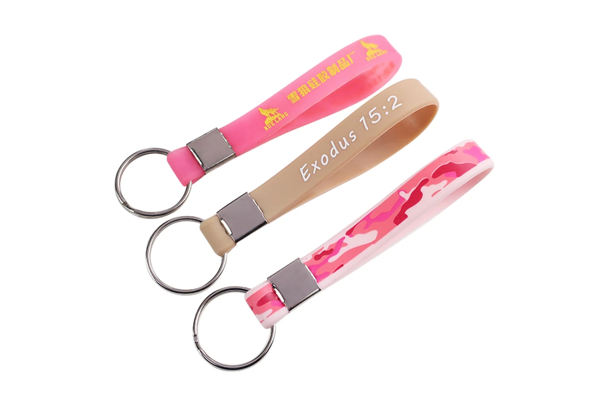 Pink and beige silicone wristlet keychains with silver-colored fittings.