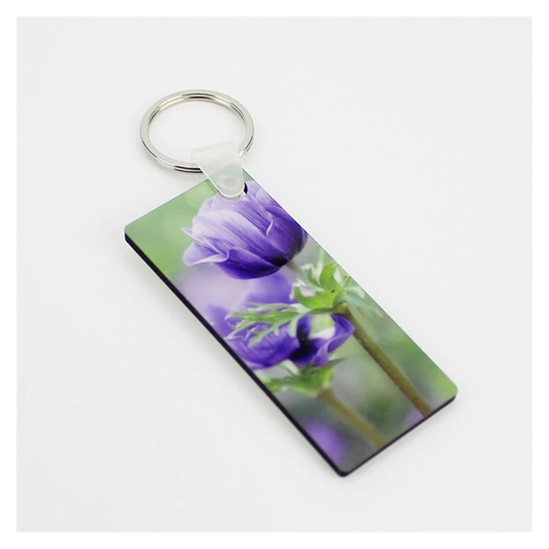 Rectangular wooden keychain with a purple flower print and silver-tone ring.