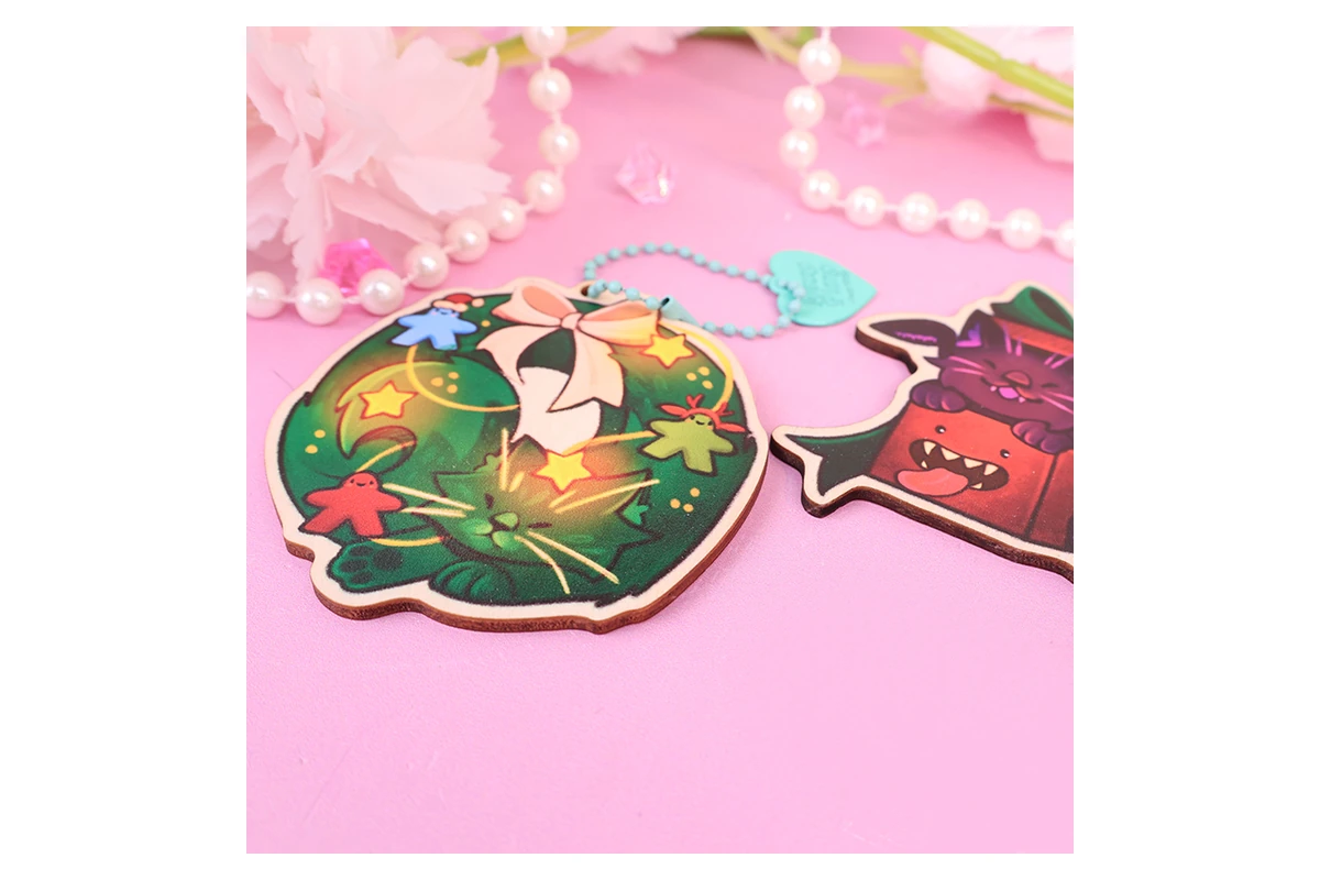 Colorfully printed wooden character charms with shaped outlines.