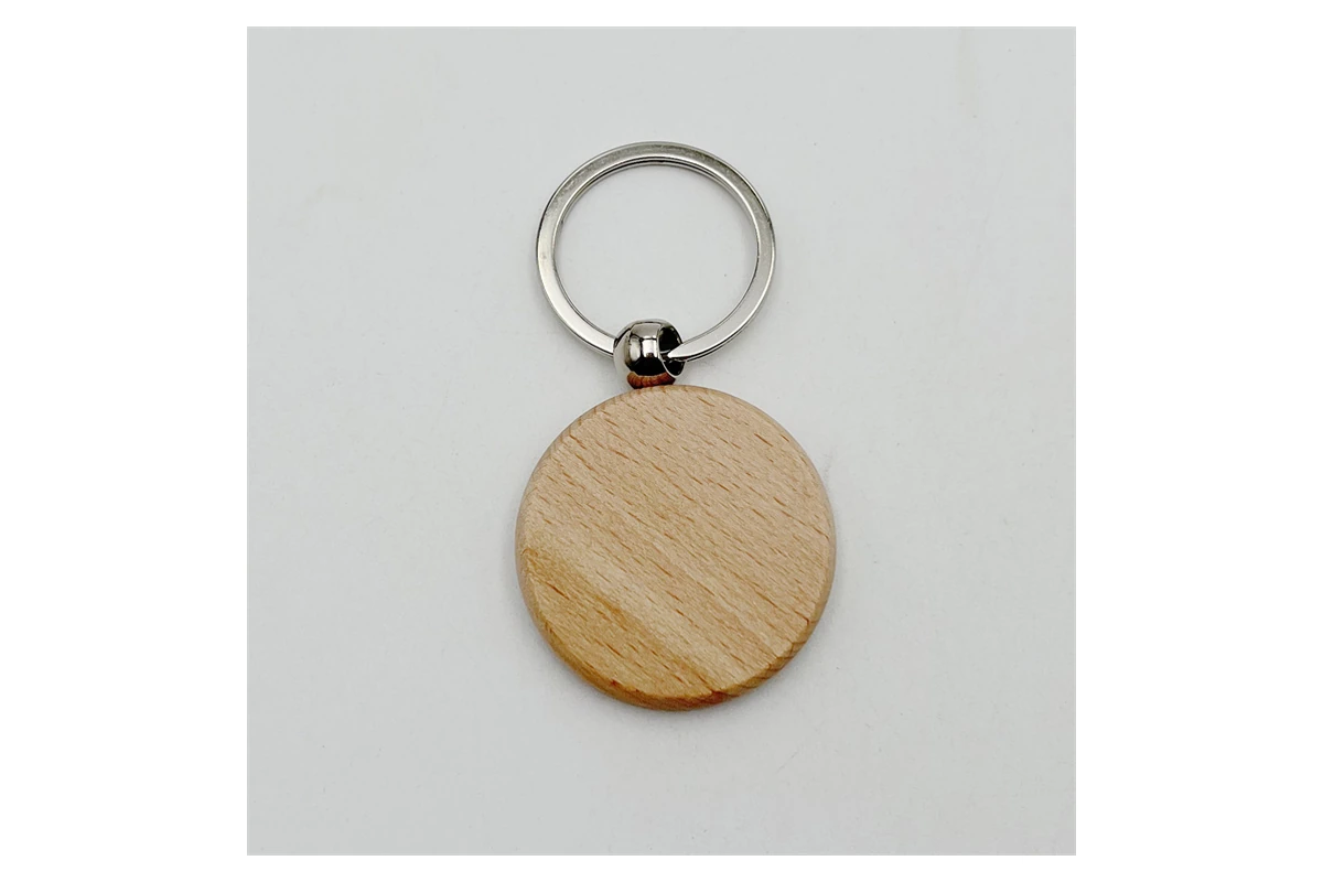 Plain round wooden keychain showing its grain and smooth edge.