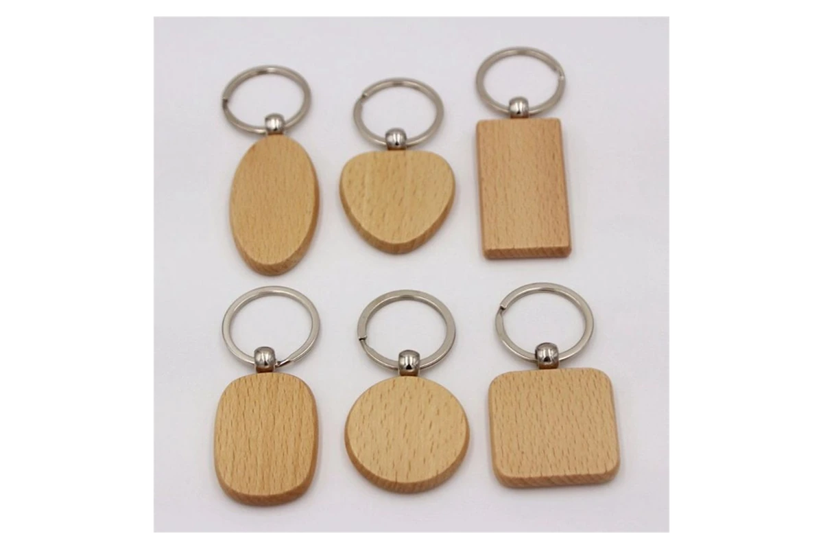 Six wooden keychain blanks with round, heart, oval and rectangular outlines.