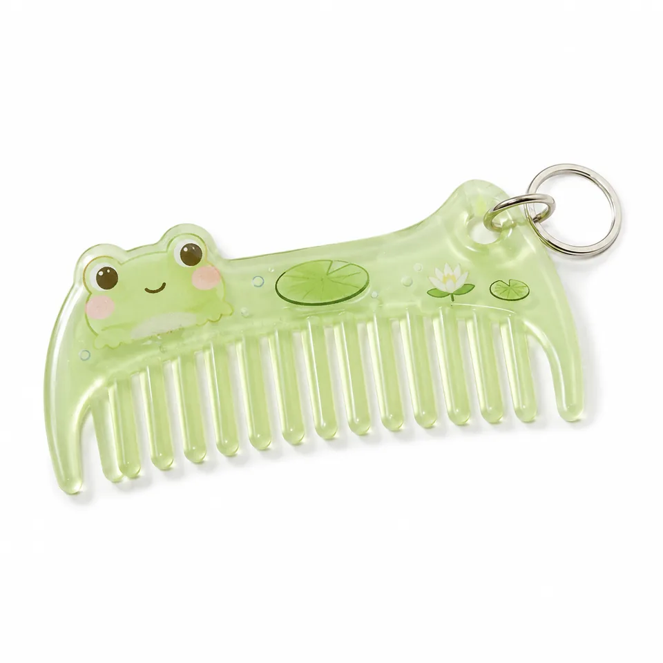 Translucent green comb keychain with a frog, lily pads, and a silver-tone split ring.