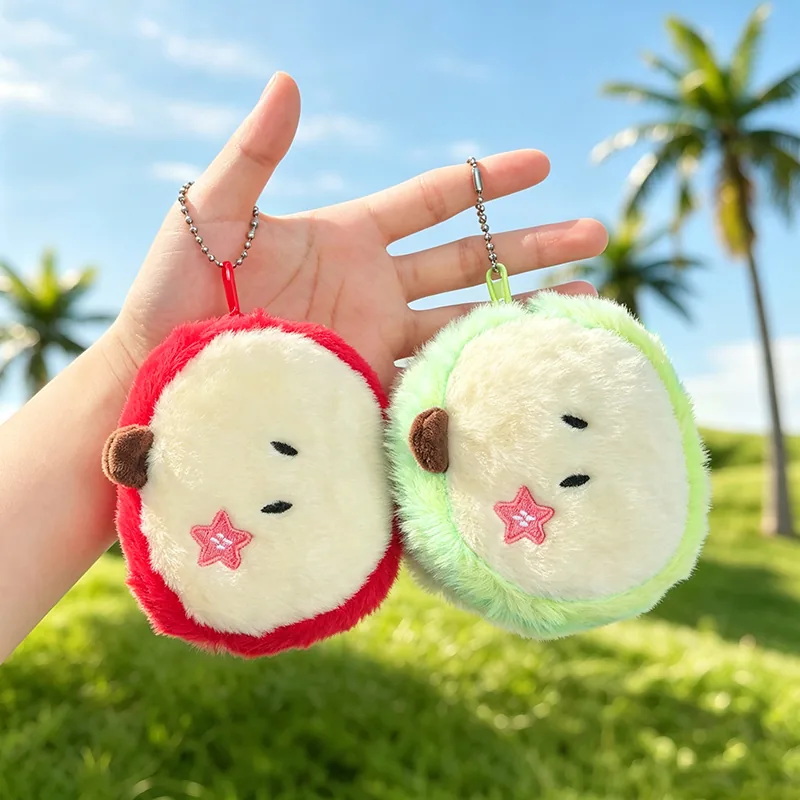 Red and green plush apple coin purse keychains hanging from bead chains.