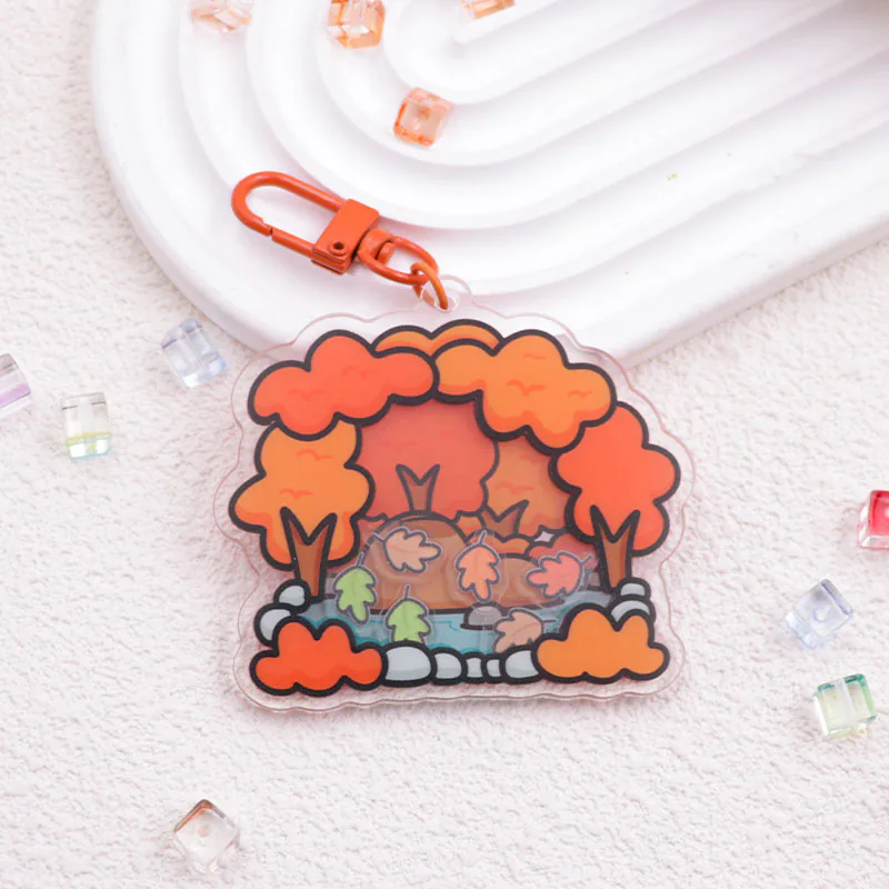 Autumn woodland charm with orange trees, small animals, and a matching orange clasp.