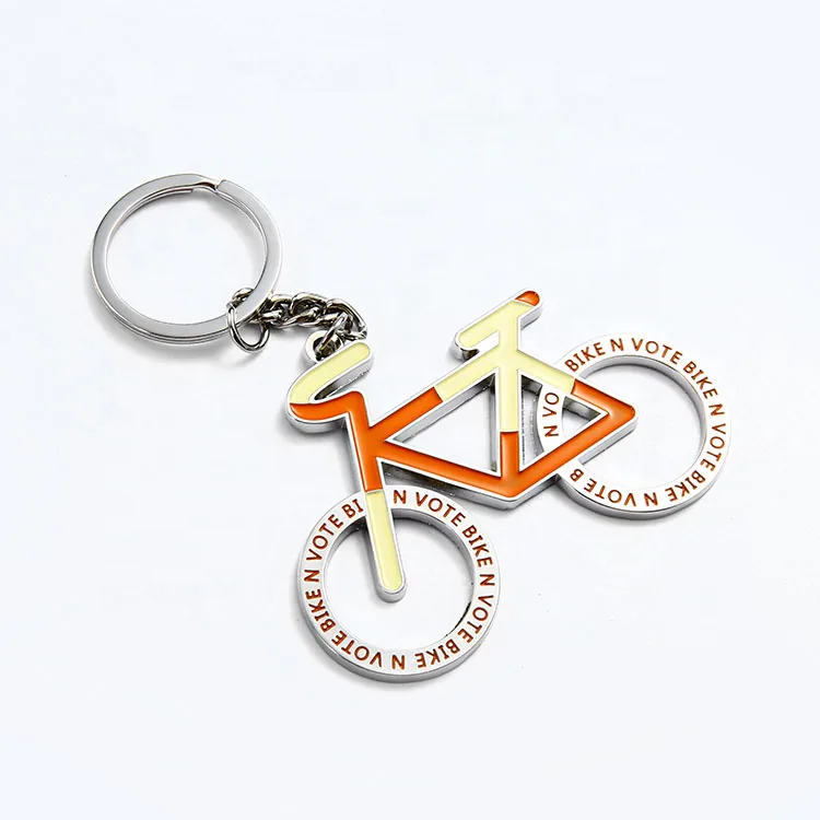 Orange and cream bicycle keychain with lettering around the wheels.