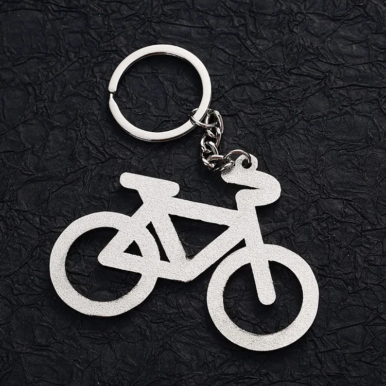 Back of a bicycle-shaped keychain with a textured silver-tone finish.