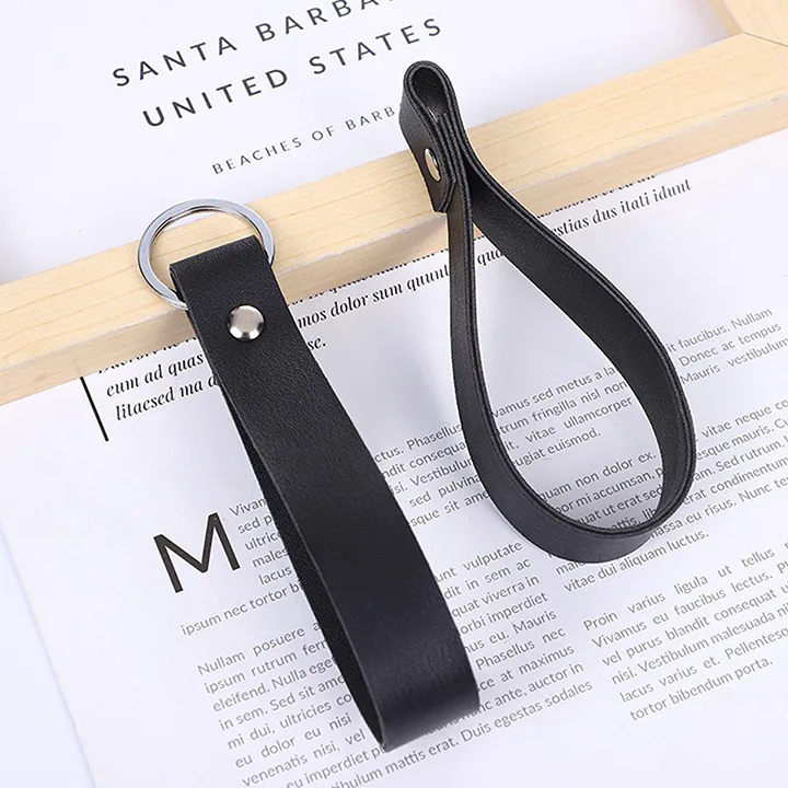 Black loop key fobs with round silver-tone rivets and split rings.