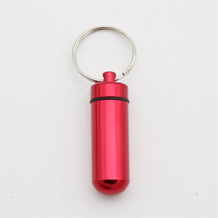 Red cylindrical container keychain with a screw-top lid and black sealing ring.