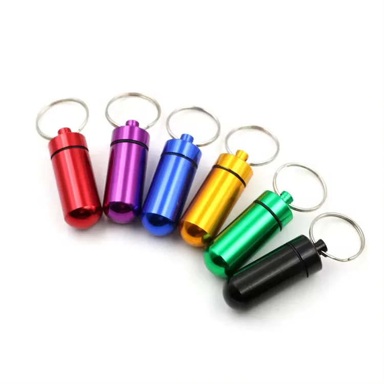 Capsule container keychains in red, purple, blue, gold, green, and black.