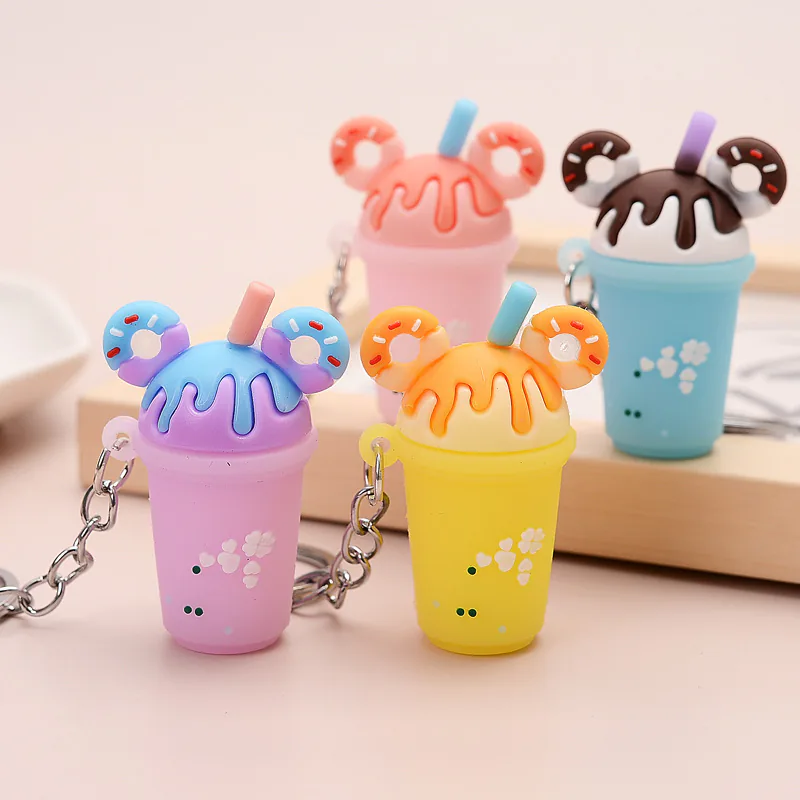 Pink, purple, yellow, and blue drink-cup keychains with straws and donut decorations.
