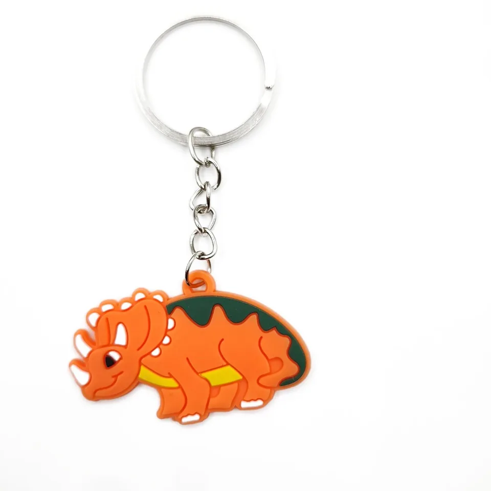 Orange triceratops keychain with a green back, yellow belly, and a silver-tone ring.