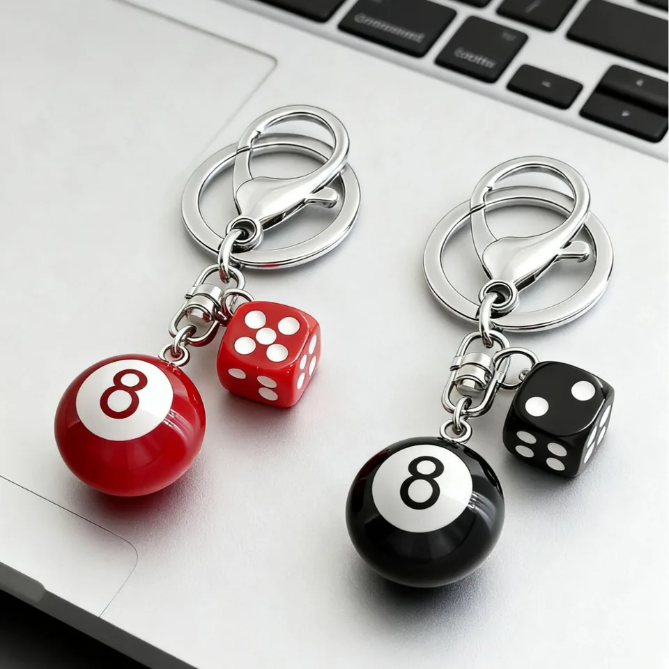 Red and black eight-ball keychains with matching dice and silver-tone clasps.