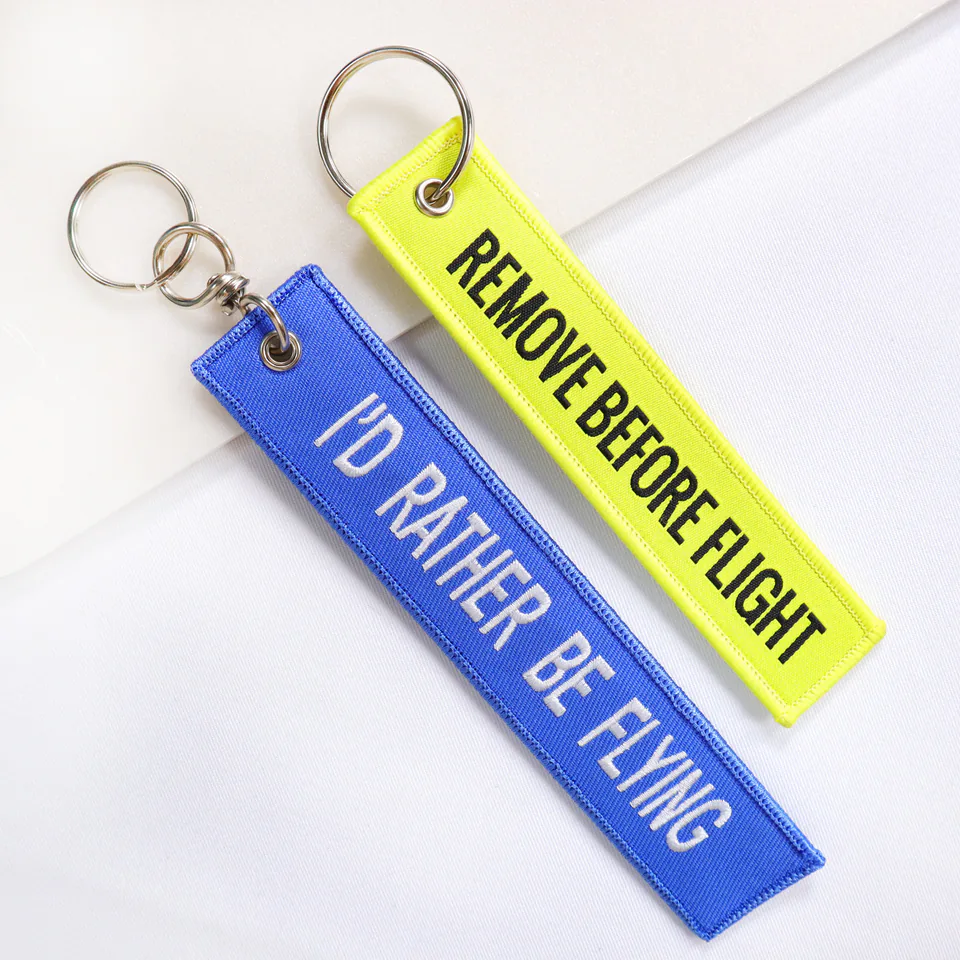 Blue and neon yellow flight tags with “I’D RATHER BE FLYING” and “REMOVE BEFORE FLIGHT” lettering.