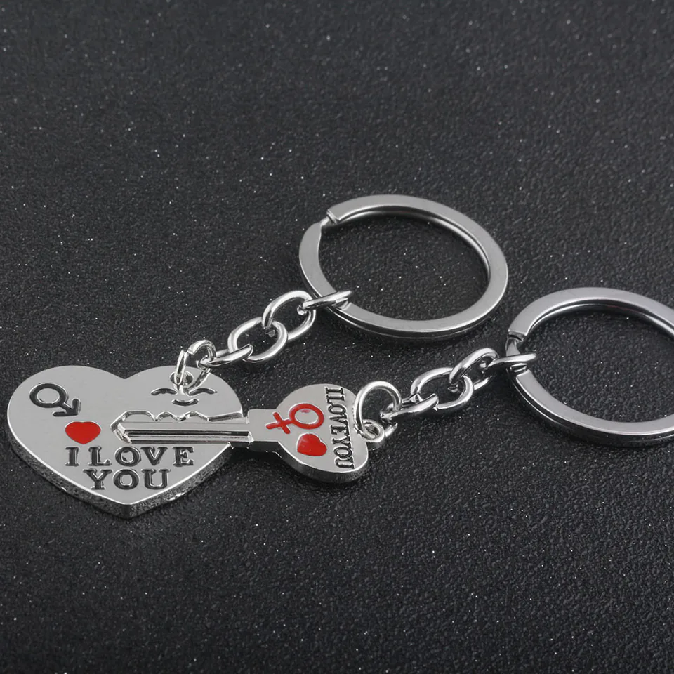 Silver-tone heart and key charms shown together with red heart details and short chains.