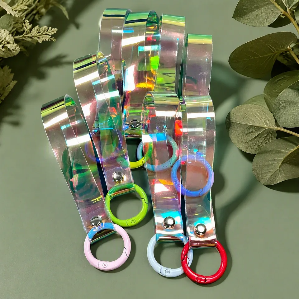 Iridescent wristlet keychains with pink, green, blue, and red round clasps.