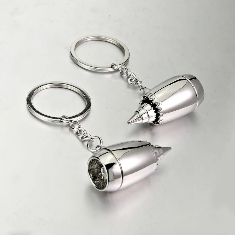 Two silver-tone jet engine keychains showing the intake and exhaust ends.