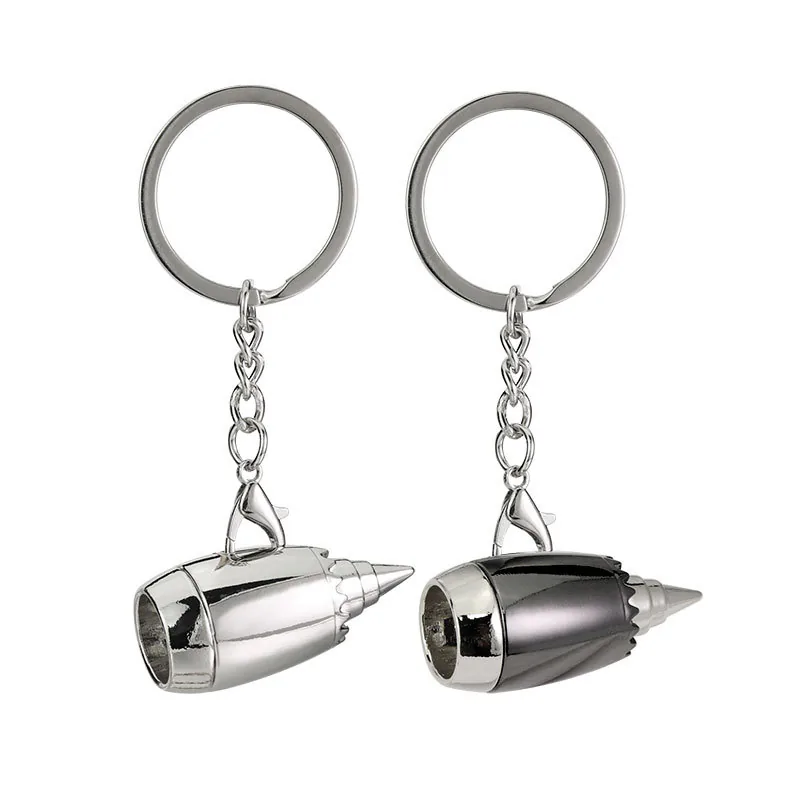 Silver and dark gray jet engine keychains with round split rings.