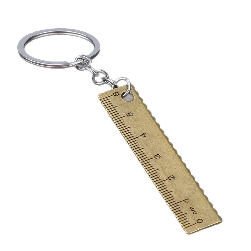 Brass-tone ruler keychain with centimeter markings and a silver-tone split ring.
