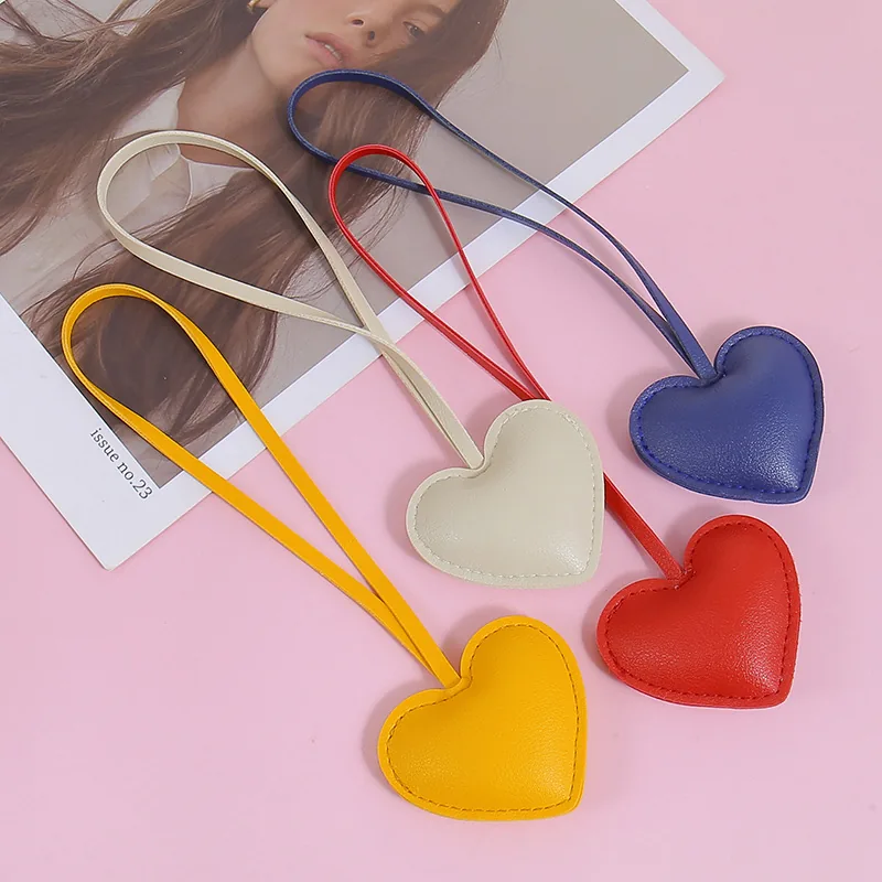 Yellow, cream, red, and blue padded heart charms with matching attachment loops.