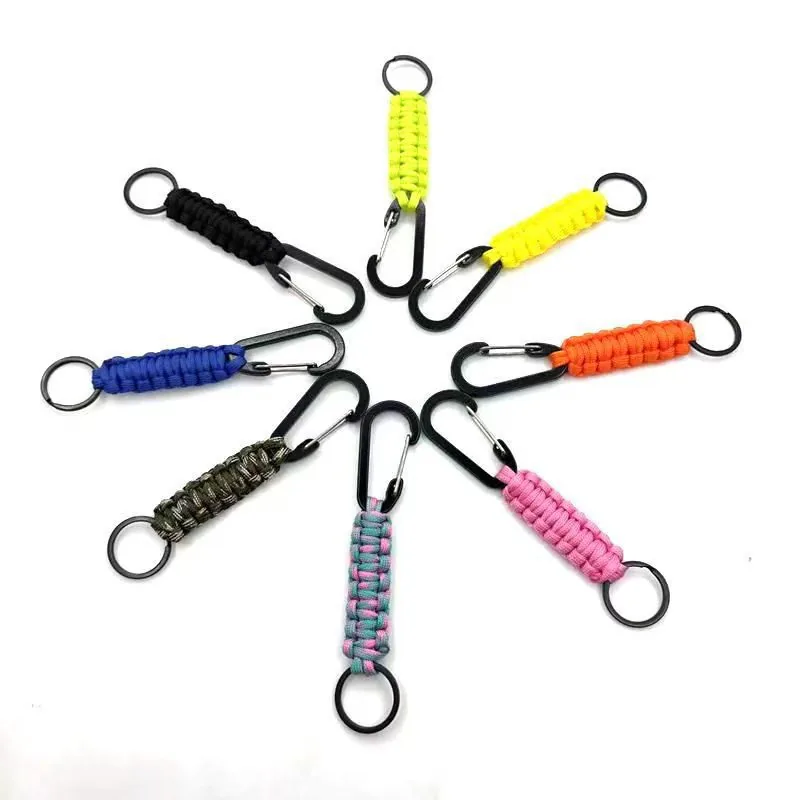 Eight braided cord keychains in assorted colors with black clips and split rings.