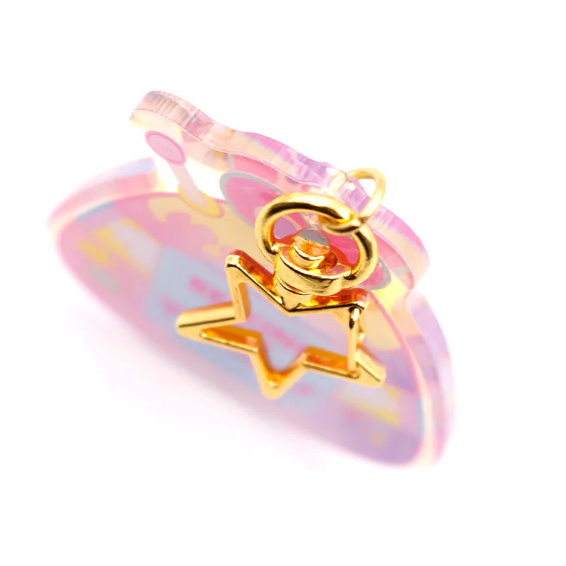 Side view of a pastel potion bottle charm showing its clear edge and gold-tone star clasp.