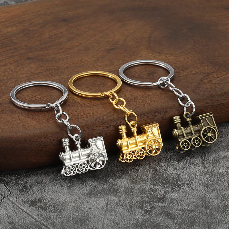 Steam locomotive keychains in silver, gold, and antique brass tones.