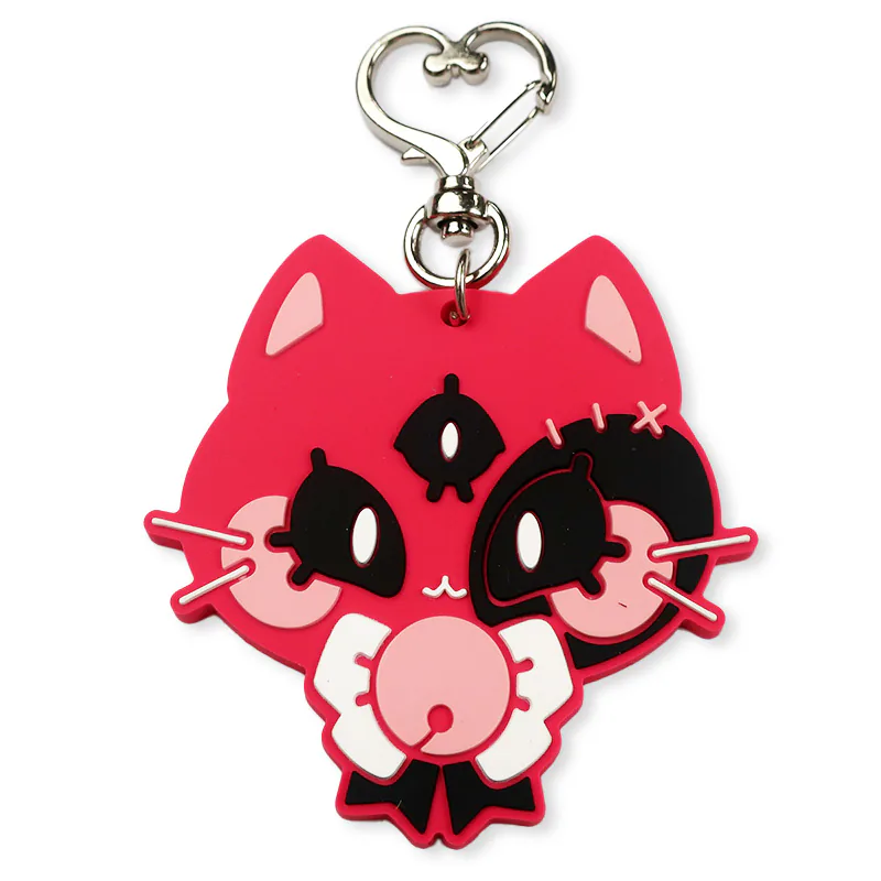 Hot pink three-eyed cat keychain with a silver heart-shaped clasp.