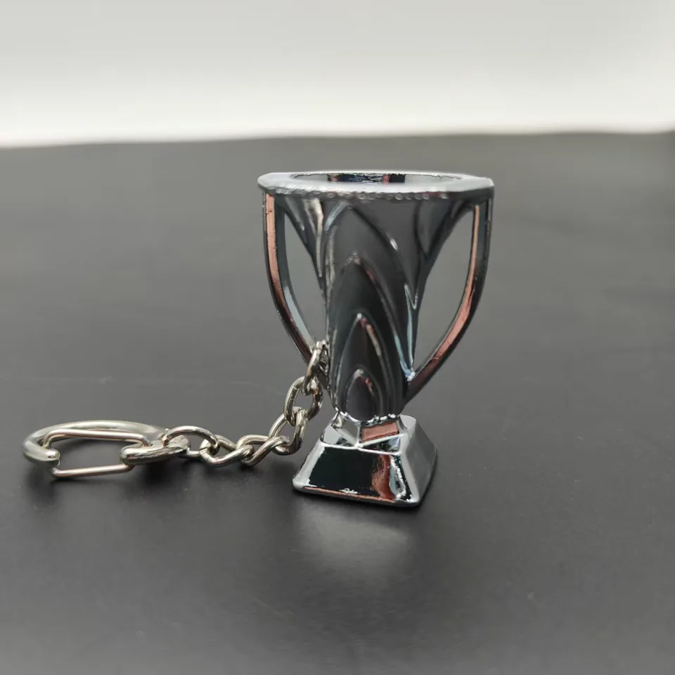 Silver-tone trophy cup keychain with a square base and lobster clasp.