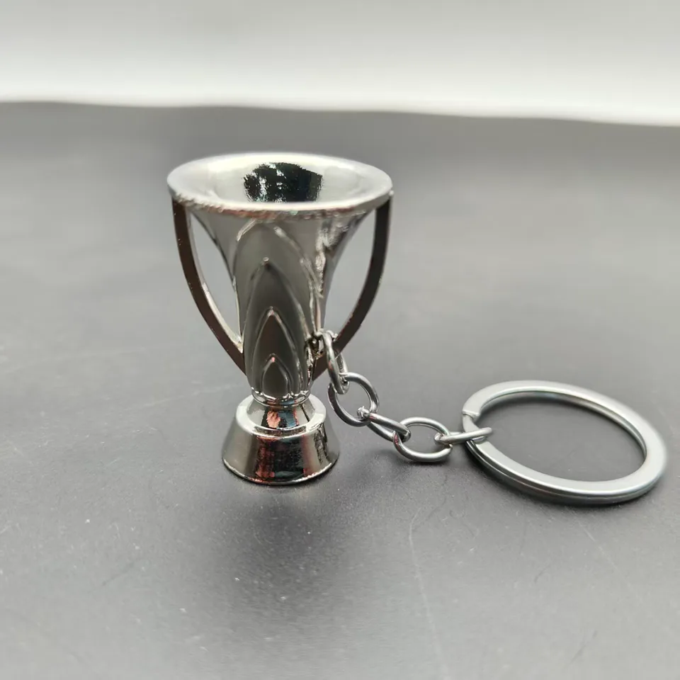 Silver-tone trophy cup keychain with a round base and split ring.