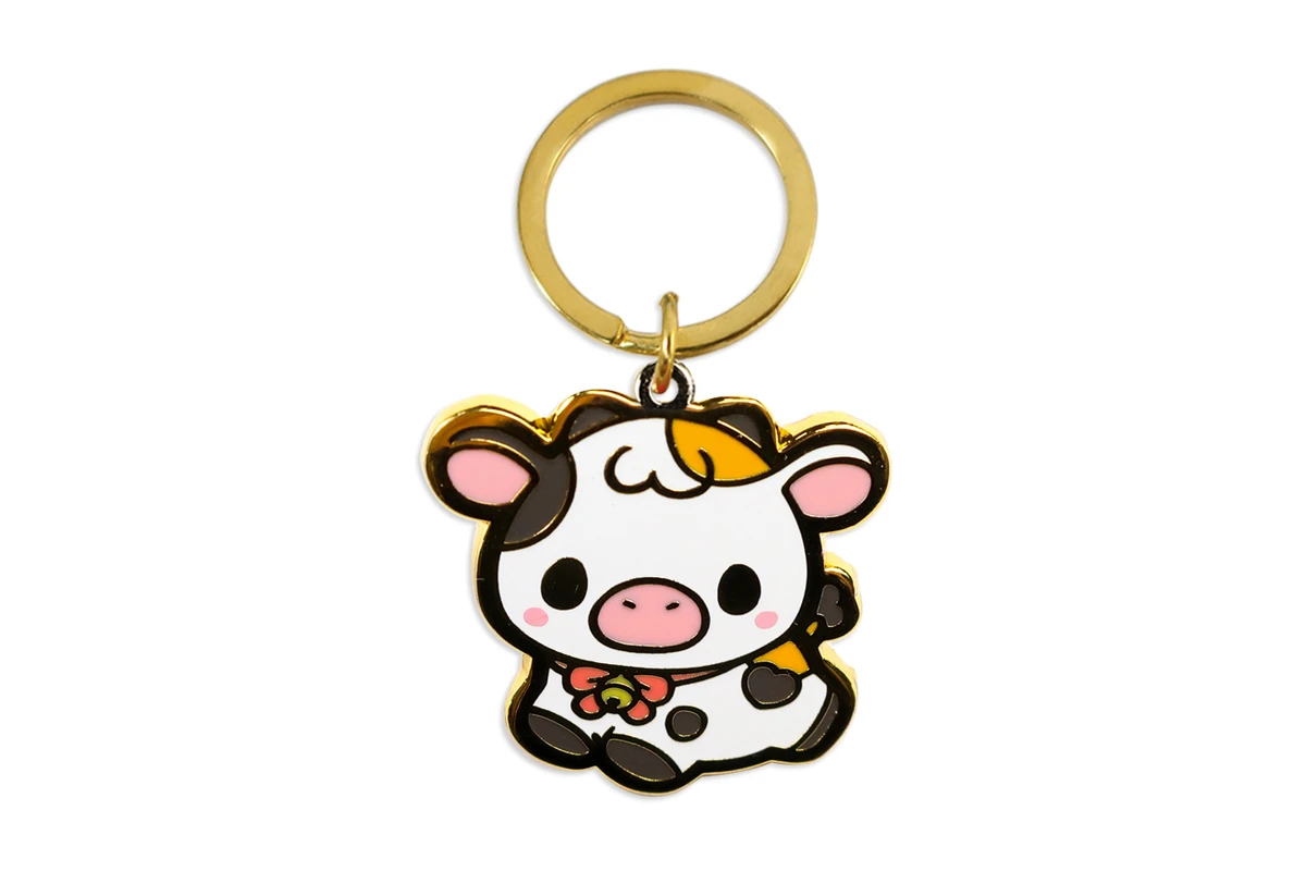 Cow-shaped keychain with colored details and a gold-tone ring.